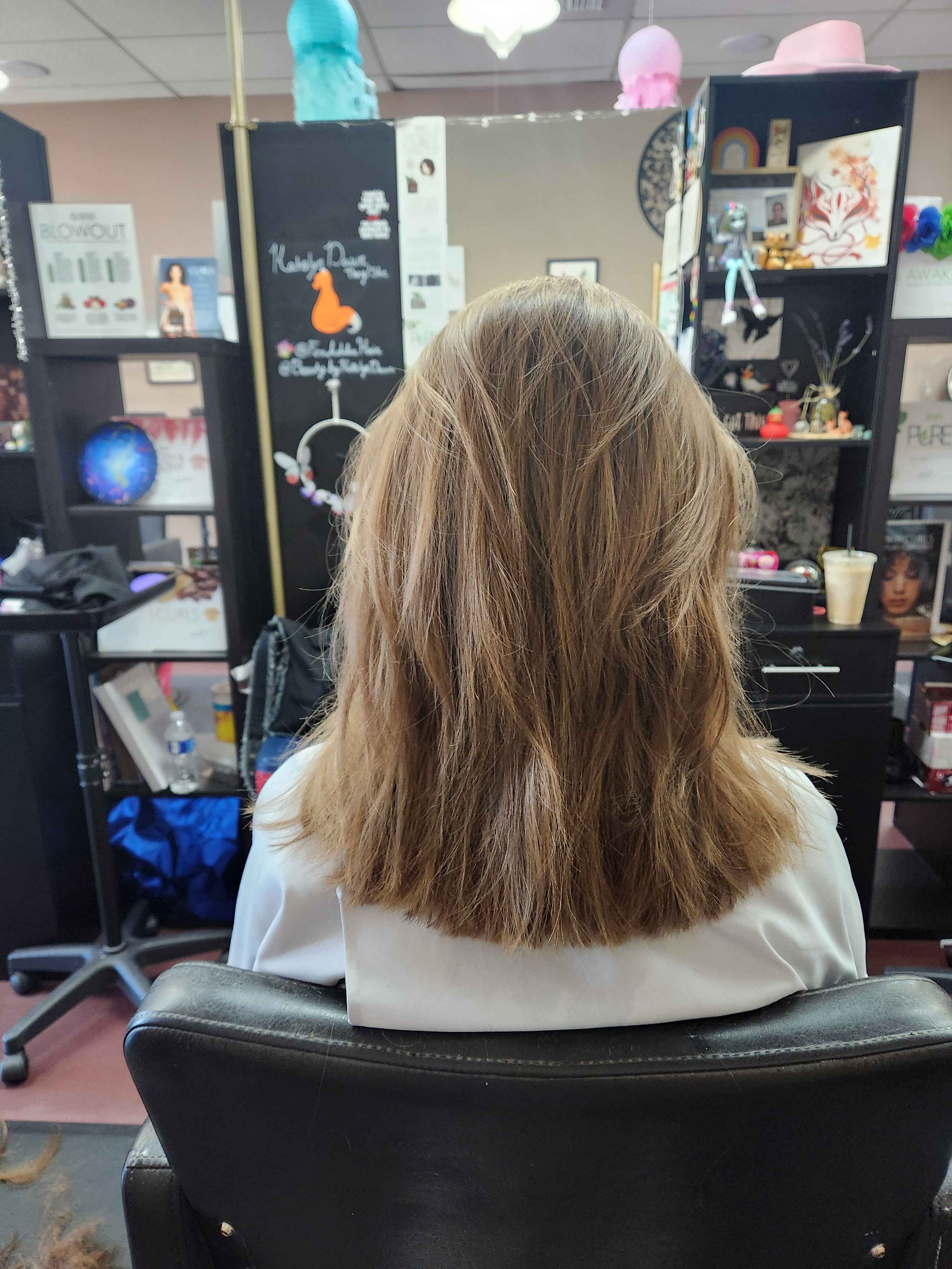 The same client as before with shoulder-length layered hair. It has a simple blowout style.