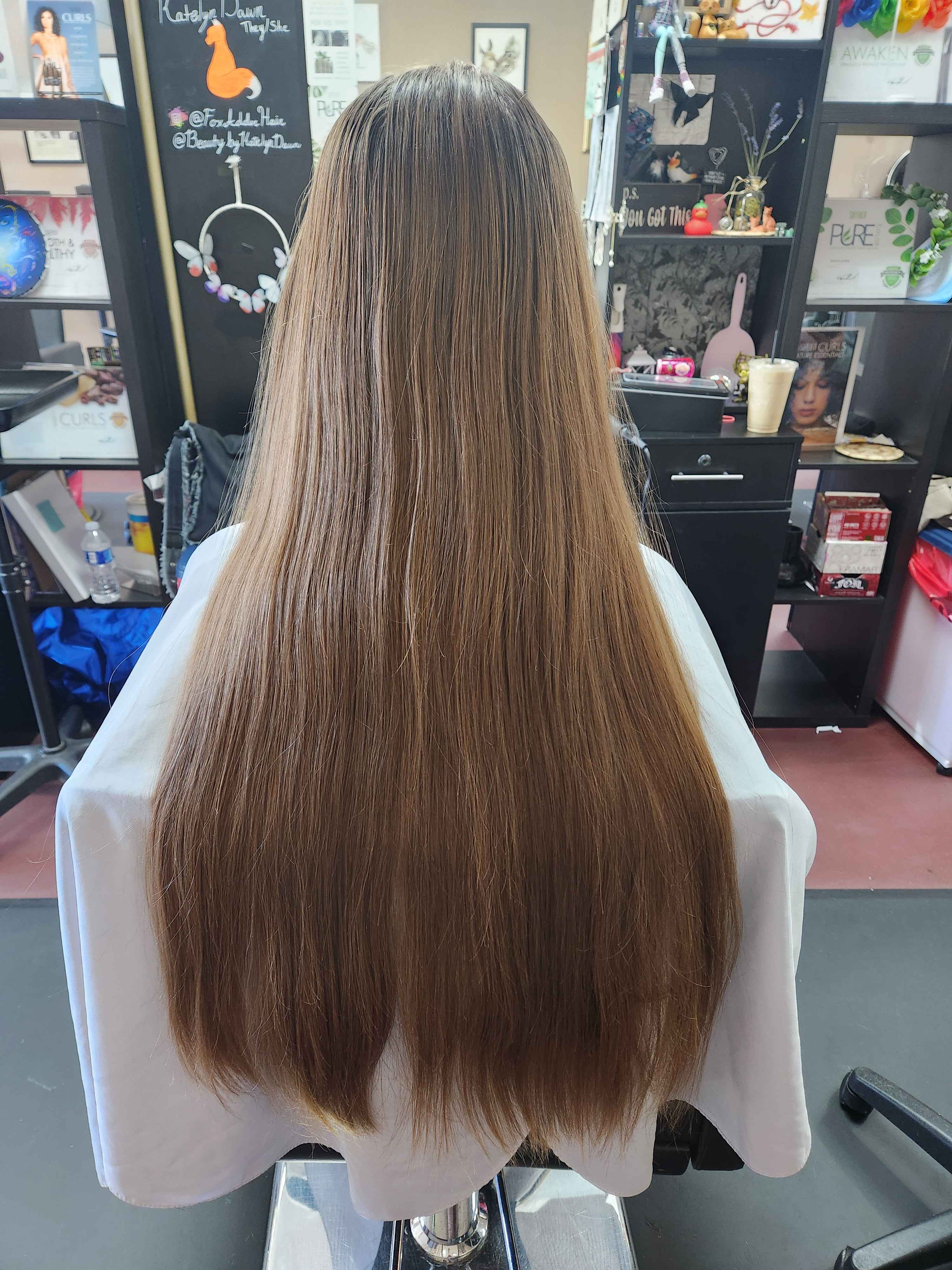 A client with long, waist-length hair with no layering.