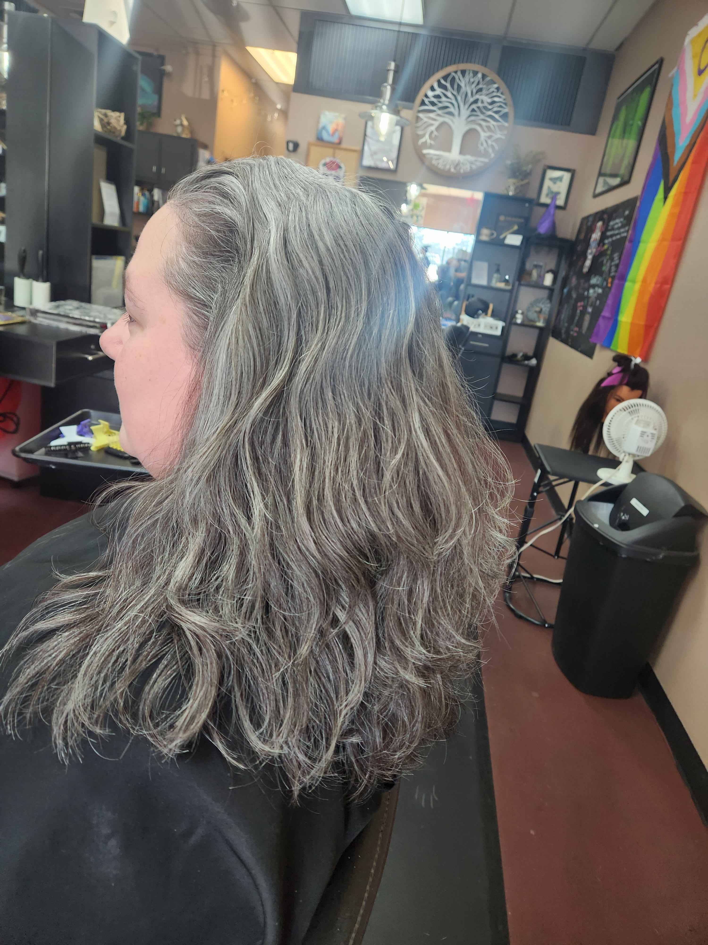 client with shoulder-length multi-dementional natural grey hair.